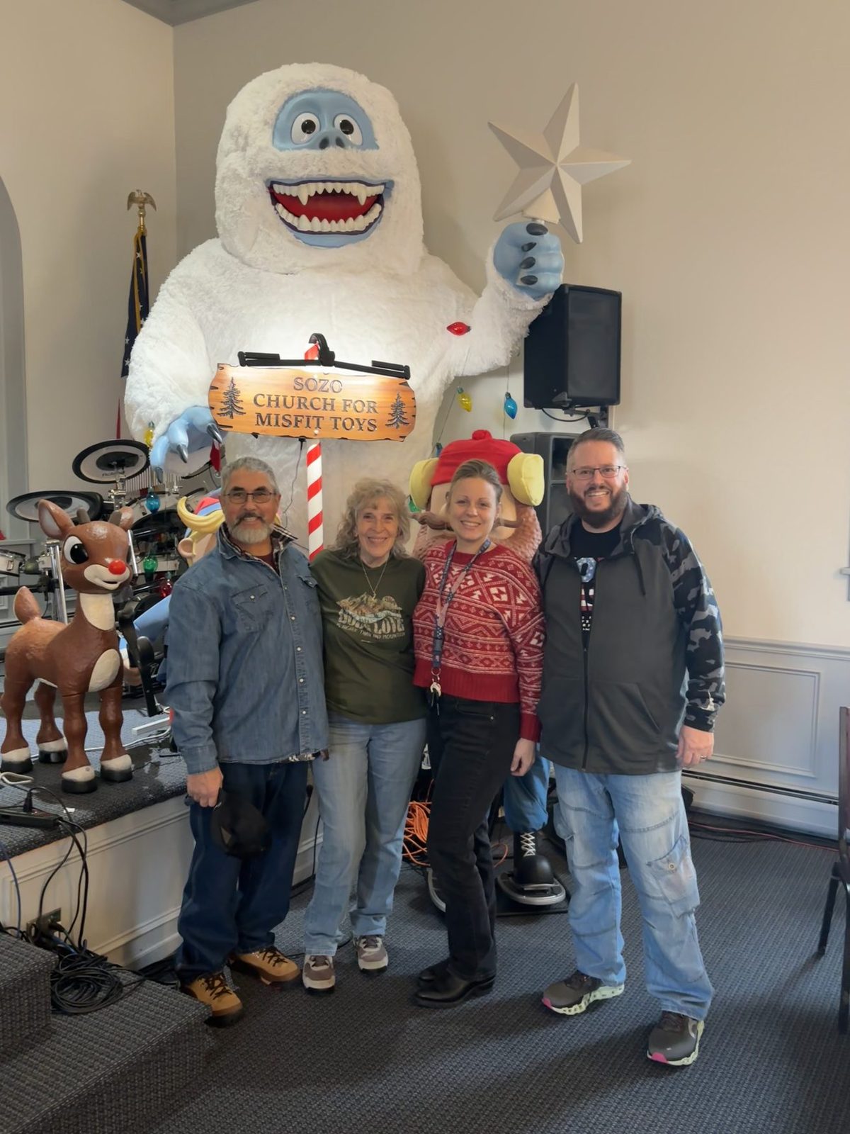 Friends under the Sozo Church for Misfit Toys sign in the sanctuary